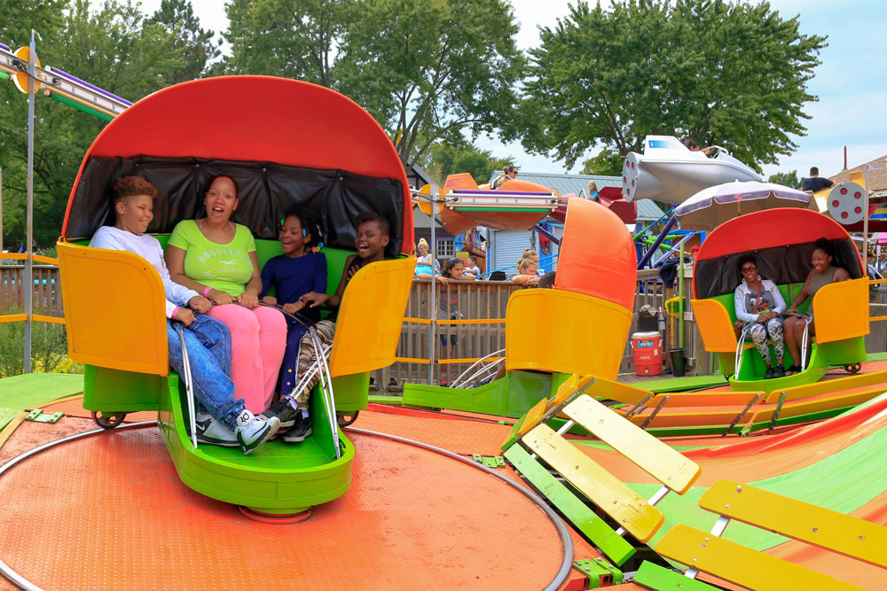 families have fun on the tilt-o-whirl